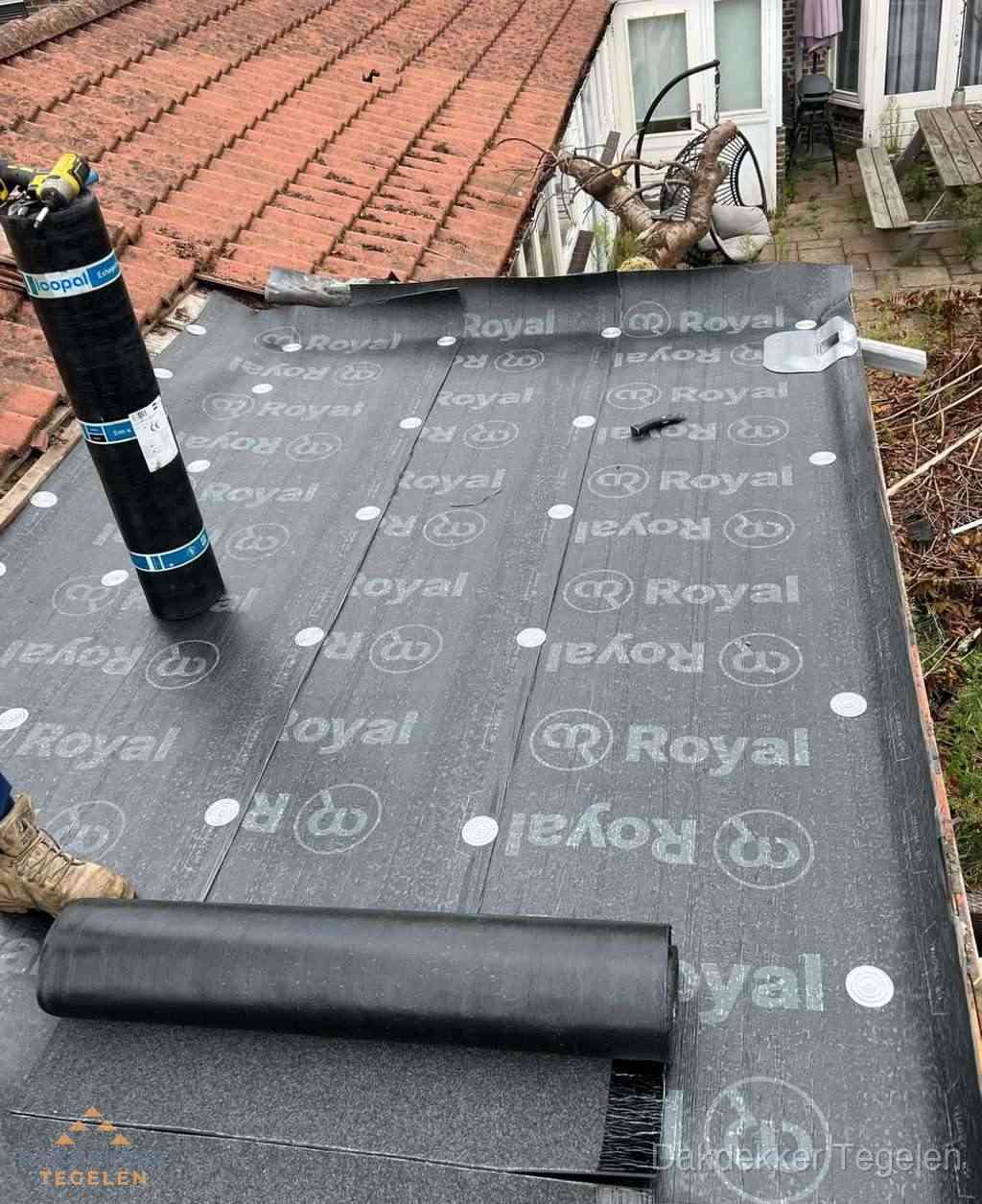 Plat dak met nieuwe bitumen dakbedekking en brandgereedschap in Tegelen